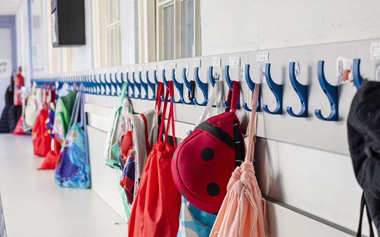 Coats and bags hung up on pegs in a primary school in the North East of England.